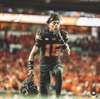 an image of a football player holding a microphone