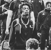 a black and white photo of a group of people with dreadlocks